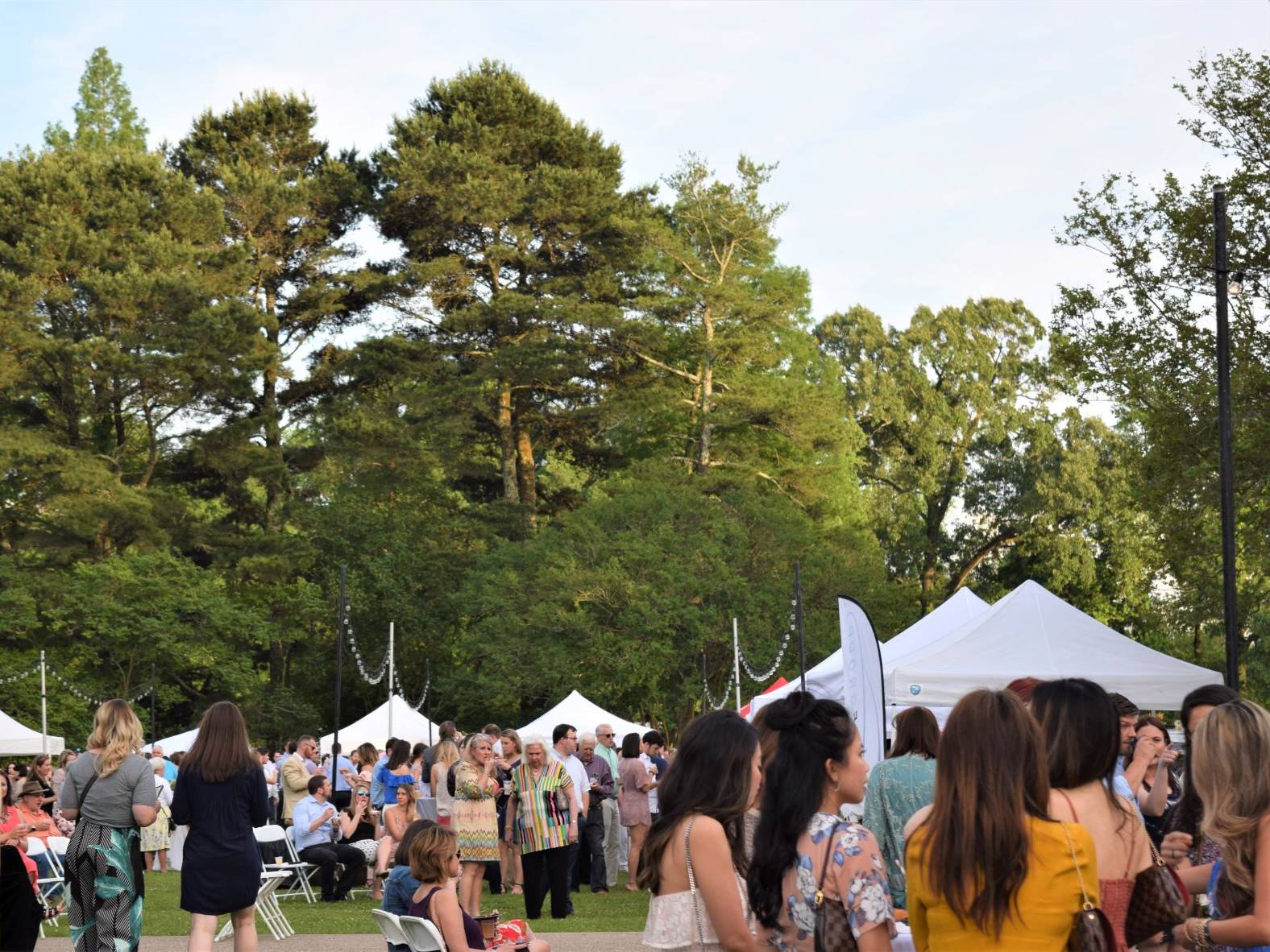 large group of people gathered causally in garden setting