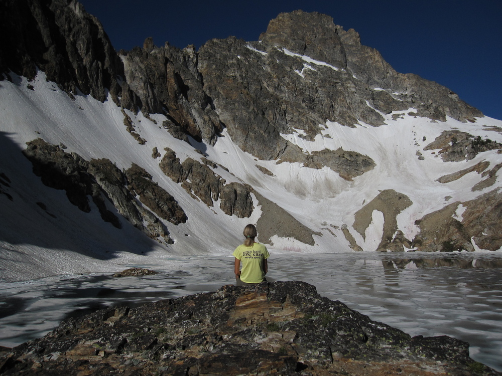 a student sitting with a mountain in the background